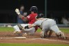Cleveland Guardians' Gabriel Arias left, scores next to Detroit Tigers catcher Jake Rogers during the fifth inning of a baseball game Saturday, Aug. 19, 2023, in Cleveland. (AP Photo/Sue Ogrocki)
