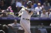 Chicago White Sox's Yoan Moncada follows the flight of his double to drive in two runs against Colorado Rockies relief pitcher Matt Koch in the eighth inning of a baseball game Sunday, Aug. 20, 2023, in Denver. (AP Photo/David Zalubowski)