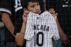 A baseball fan waits to get an autograph from Chicago White Sox third baseman Yoan Moncada before a baseball game against the Seattle Mariners in Chicago, Monday, Aug. 21, 2023. (AP Photo/Nam Y. Huh)