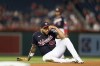 Washington Nationals first baseman Dominic Smith (22) reacts after he was unable to get the out on Miami Marlins' Garrett Hampson at first during the fourth inning of a baseball game Thursday, Aug. 31, 2023, in Washington. (AP Photo/Stephanie Scarbrough)
