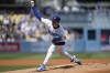 Los Angeles Dodgers starting pitcher Bobby Miller (70) throws during the first inning of a baseball game against the Atlanta Braves in Los Angeles, Sunday, Sept. 3, 2023. (AP Photo/Ashley Landis)