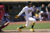 Oakland Athletics' Tony Kemp, right, watches his two-run single that scored Ryan Noda and Zack Gelof during the seventh inning of a baseball game against the Los Angeles Angels in Oakland, Calif., Sunday, Sept. 3, 2023. Athletics' Brent Rooker also scored on the play after a throwing error by Angels center fielder Mickey Moniak. (AP Photo/Jeff Chiu)