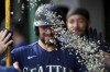 Seattle Mariners' Cal Raleigh is pelted with sunflower seeds in the dugout after hitting a solo home run during the fourth inning of a baseball game against the Cincinnati Reds in Cincinnati, Wednesday, Sept. 6, 2023. (AP Photo/Aaron Doster)