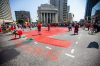 MIKAELA MACKENZIE / WINNIPEG FREE PRESS
A red dress is painted at the centre of Portage and Main before a round dance calling for the landfills to be searched takes place on Thursday.