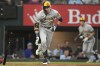 Milwaukee Brewers' Christian Yelich runs after hitting a double that scored teammate Tyrone Taylor during the fourth inning of a baseball game against the Texas Rangers in Arlington, Texas, Sunday, Aug. 20, 2023. (AP Photo/LM Otero)