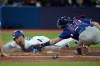 Texas Rangers catcher Jonah Heim (28) tags out Toronto Blue Jays centre fielder Kevin Kiermaier (39) during fifth inning MLB baseball action in Toronto, Monday, Sept. 11, 2023. THE CANADIAN PRESS/Nathan Denette