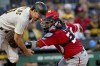 Washington Nationals catcher Keibert Ruiz, right, reaches to tag out Pittsburgh Pirates' Bryan Reynolds, left, on a steal-attempt at home plate in the third inning of a baseball game in Pittsburgh, Monday, Sept. 11, 2023. (AP Photo/Matt Freed)