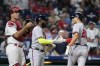 Atlanta Braves' Matt Olson, right, and Marcell Ozuna, center, celebrate past Philadelphia Phillies catcher J.T. Realmuto after Olson's home run during the fourth inning of a baseball game, Tuesday, Sept. 12, 2023, in Philadelphia. (AP Photo/Matt Slocum)