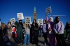 People hold signs during a demonstration on Parliament Hill in Ottawa on Wednesday, Sept. 20, 2023. Protests and counter-protests for and against Canada's trans and LGBTQ community are being planned across Canada on Wednesday. THE CANADIAN PRESS/Sean Kilpatrick