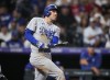 Los Angeles Dodgers' Freddie Freeman watches his three-run home run off Colorado Rockies relief pitcher Justin Lawrence during the eighth inning of a baseball game Wednesday, Sept. 27, 2023, in Denver. (AP Photo/David Zalubowski)