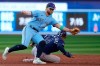 The playoff waiting game continued for the Toronto Blue Jays on Saturday afternoon after they dropped a 7-5 decision to the Tampa Bay Rays. Tampa Bay Rays catcher Christian Bethancourt (14) is safe at third base after Toronto Blue Jays shortstop Bo Bichette (11) can't get to the throw during sixth inning American League MLB baseball action in Toronto, Saturday, Sept. 30, 2023. THE CANADIAN PRESS/Frank Gunn