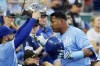 Kansas City Royals' Kyle Isbel, left, gives Salvador Perez, right, the team's home run award after hitting a solo homer during the third inning of a baseball game against the New York Yankees in Kansas City, Mo., Saturday, Sept. 30, 2023. (AP Photo/Colin E. Braley)