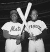 FILE - New York Mets right fielder Joe Christopher, left, crosses bats with San Francisco Giants center fielder Willie Mays at Shea Stadium on May 29, 1964, in New York. Christopher, an outfielder on the 1962 expansion Mets, died Tuesday, Oct. 3, 2023, in Edgewood, Md. He was 87. The Mets said he died at his home, where he was receiving hospice care. (AP Photo, File)
