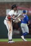 Atlanta Braves' Ronald Acuna Jr. (13) holds up the bag after stealing second base in the 10th inning of a baseball game against the Chicago Cubs, Wednesday, Sept. 27, 2023, in Atlanta. The stolen base was Acuna's 70th of the season. (AP Photo/John Bazemore)