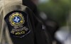 Quebec provincial police say they have arrested 10 people in connection with an alleged grandparent fraud scheme linked to organized crime. A Surete du Quebec emblem is seen on an officer’s uniform in Montreal, Aug. 22, 2023. THE CANADIAN PRESS/Christinne Muschi