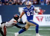 Winnipeg Blue Bombers' Dalton Schoen (83) escapes the tackle by B.C. Lions' T.J. Lee (6) to run the ball in for a touchdown during first half CFL action in Winnipeg Thursday, August 3, 2023. THE CANADIAN PRESS/John Woods