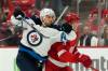 Carlos Osorio / The Associated Press
                                Jets forward Nino Niederreiter works his way around Red Wings defenceman Justin Holl Thursday night in Detroit.