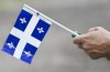 The Quebec government says it will delay the opening of an office in Israel, scheduled for next week, in the wake of attacks on the country. A person holds a Quebec flag on St-Jean-Baptiste Day in Montreal, Saturday, June 24, 2023. THE CANADIAN PRESS/Graham Hughes