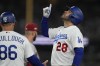 Los Angeles Dodgers' J.D. Martinez celebrates at first base after hitting a single during the sixth inning in Game 2 of a baseball NL Division Series against the Arizona Diamondbacks, Monday, Oct. 9, 2023, in Los Angeles. (AP Photo/Ashley Landis)