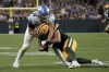 Green Bay Packers tight end Luke Musgrave (88) is tackled by Detroit Lions linebacker Alex Anzalone (34) after catching a pass during the first half of an NFL football game, Thursday, Sept. 28, 2023, in Green Bay, Wis. (AP Photo/Morry Gash)