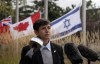The flags of Ontario, Canada and Israel fly at half mast as Jewish Federation of Ottawa CEO Andrea Freedman reads a statement from the family of Ali Vital-Kaploun who was killed by Hamas, on Wednesday, October 11, 2023 in Ottawa. THE CANADIAN PRESS/Adrian Wyld