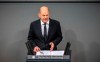 German Chancellor Olaf Scholz delivers a government statement on the situation in Israel during a meeting of the German federal parliament, Bundestag, at the Reichstag building in Berlin, Germany, Thursday, Oct. 12, 2023. (Michael Kappeler/dpa via AP)