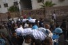 FILE - Palestinians, including some journalists, carry the bodies of two Palestinian reporters, Mohammed Soboh and Said al-Tawil, who were killed by an Israeli airstrike in Gaza City, Tuesday, Oct. 10, 2023. Journalists reporting in Gaza need to worry about basic survival for themselves and their families in addition to getting out the story of a besieged population. There are a limited number of journalists in the Palestinian territory, with new ones not being allowed in since the war between Israel and Hamas started. (AP Photo/Fatima Shbair)