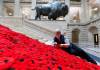 MIKE DEAL / WINNIPEG FREE PRESS
                                Susan Wakeman, one of the volunteers that help maintain the Poppy Blanket, reattaches one of the handmade poppies to the blanket on the Grand Staircase Monday morning. First unveiled in November of 2019 the Poppy Blanket is an 85 foot long collection of over 8000 handmade poppies and thousands of dedicated ribbons. It was made in less than a year between 2018 and 2019 by the Handmade Winnipeg Facebook group community. 231106 - Monday, November 06, 2023.