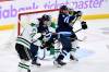 THE CANADIAN PRESS/Fred Greenslade
                                Winnipeg Jets&rsquo; Mark Scheifele, left, tries to deflect a shot on Dallas Stars goaltender Jake Oettinger as Jani Hakanpaa ties up Alex Iafallo during the first period in Winnipeg on Tuesday.