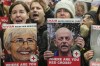 FILE - A person at left holds a poster of Vivian Silver as medical staff and health professionals attend a demonstration in front of the International Committee of the Red Cross (ICRC) in London, Thursday, Nov. 9, 2023, calling for an immediate intervention in the case of the hostages kidnapped from Israel on Oct. 7. Vivian Silver, a Canadian-born Israeli activist who devoted her life to seeking peace with the Palestinians, was confirmed killed in Hamas' Oct. 7 attacks in southern Israel. (AP Photo/Kin Cheung, File）