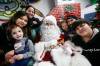 JOHN WOODS / WINNIPEG FREE PRESS Breanne Durocher and Willis Ducharme with their children, from left, Aubrey, Addisyn, Niko and Khaedon visit with Santa.