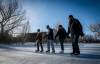 Ryan and Laura Rusell skate with their sons Carson, 14, and Owen, 12, on the duck pond in Assiniboine Park Sunday. (John Woods / Winnipeg Free Press)