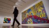 A sentencing hearing for one of several people charged in what's been called a historic case of art fraud is underway in a Thunder Bay, Ont., courtroom. A reporter walks past 'Androgyny' by Norval Morrisseau, right, and 'Tweaker' by Lawrence Paul Yuxweluptun during a media tour of the Canadian and Indigenous Art: 1968 to Present at the National Gallery of Canada's contemporary art galleries, in Ottawa, Tuesday, May 2, 2017. THE CANADIAN PRESS/Adrian Wyld