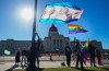 People hold pride flags while attending a rally against the Saskatchewan government's legislation on pronouns in schools, in front of Saskatchewan legislature in Regina, on Tuesday, Oct. 10, 2023. THE CANADIAN PRESS/Heywood Yu