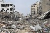 Countries aligned with Israel are warning the country's right-wing government against contemplating a forced displacement of Gaza residents, as officials repeatedly suggest Canada should take in Palestinians. Palestinians walk past the building destroyed in the Israeli Bombardment of the Gaza Strip in Gaza City, Wednesday, Jan. 3, 2024. THE CANADIAN PRESS/AP-Mohammed Hajjar