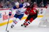 Edmonton Oilers center Connor McDavid (97) fends off New Jersey Devils defenseman Luke Hughes (43) during the third period of an NHL hockey game in Newark, N.J., Thursday, Dec. 21, 2023. The Oilers won 6-3. (AP Photo/Peter K. Afriyie)