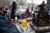 Homeless people and supporters have a stand off and refuse to leave the encampment as police prepare to clear homeless encampments in Edmonton, Tuesday, Jan. 9, 2024. THE CANADIAN PRESS/Jason Franson.