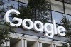 FILE - A Google sign hangs over an entrance to the company's new building, Sept. 6, 2023, in New York. Google has laid off hundreds of employees working on its hardware, voice assistance and engineering teams as part of cost-cutting measures. (AP Photo/Peter Morgan, File)