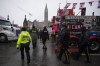Police walk through parked trucks to make an arrest on Wellington Street, on the 21st day of a protest, in Ottawa, on Thursday, Feb. 17, 2022. The Federal Court ruled Tuesday the Liberal government’s invocation of the Emergencies Act in response to the 
