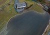 In this photograph taken with a drone; a large amount of water floods a low area of a farm near a house in Abbotsford, B.C., Wednesday, Jan. 31, 2024. A bulletin from B.C.'s River Forecast Centre says rainfall since Friday has ranged from 70 to more than 500 millimetres across the South Coast, while unseasonable warmth has added between 75 and 150 millimetres of snowmelt in recent days. THE CANADIAN PRESS/Darryl Dyck