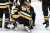 Pittsburgh Penguins' Noel Acciari (55) is attended to after taking a hit from Winnipeg Jets' Brenden Dillon (5) during the second period of an NHL hockey game, Tuesday, Feb. 6, 2024, in Pittsburgh. (AP Photo/Matt Freed)