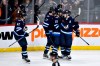 Winnipeg Jets left wing Kyle Connor (81) celebrates his game-winning goal against the Arizona Coyotes with Mark Scheifele (55) and Adam Lowry (17) during overtime NHL action in Winnipeg on Sunday February 25, 2024. THE CANADIAN PRESS/Fred Greenslade