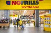Canada’s biggest grocers are investing money and space in discount stores like No Frills, Food Basics and FreshCo as shoppers look for ways to save on food. A customer pushes a shopping cart full of groceries from a NoFrills grocery store, in Toronto, on Thursday, November 23, 2023.THE CANADIAN PRESS/Chris Young