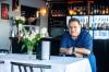 MIKAELA MACKENZIE / WINNIPEG FREE PRESS Mike Vogiatzakis, brother of Kyriakos Vogiatzakis, at the Cork and Flame on re-opening day on Friday.