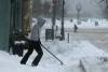 Tim Krochak / The Canadian Press
                                Snow is pushed away from a business during a winter storm in central Dartmouth, N.S. Sydney was expecting as much as 150 centimetres.