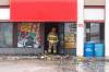 A firefighter outside the strip mall Monday morning. (Mike Deal / Winnipeg Free Press)