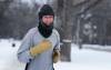 RUTH BONNEVILLE / FREE PRESS Dayton Moreton has frost collecting on his touque as he goes for his usual run down Wellington Crescent Thursday afternoon. Weather has returned to near normal temperatures this past week after above normal for most of the winter.
