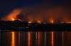 The McDougall Creek wildfire burns on the mountainside above lakefront homes in West Kelowna, B.C., on Friday, Aug. 18, 2023. THE CANADIAN PRESS/Darryl Dyck