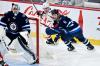 Winnipeg Jets' Colin Miller (6) skates behind goaltender Connor Hellebuyck (37) defending against Washington Capitals' Nicolas Aube-Kubel (96) during the first period of NHL action in Winnipeg on Monday March 11, 2024. THE CANADIAN PRESS/Fred Greenslade