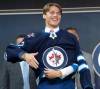 Ryan Remiorz / The Canadian Press
                                Winnipeg Jets Rutger McGroarty puts on his jersey during the first round of the 2022 NHL Draft Thursday, July 7, 2022 in Montreal. THE CANADIAN PRESS/